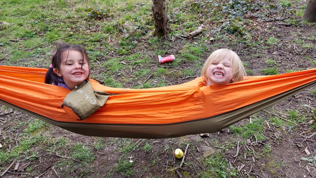 Two girls in an orange hammock